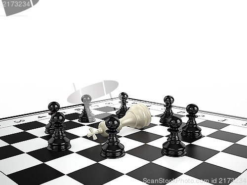 Image of The white chess king lies surrounded by black chess pawns on a chessboard