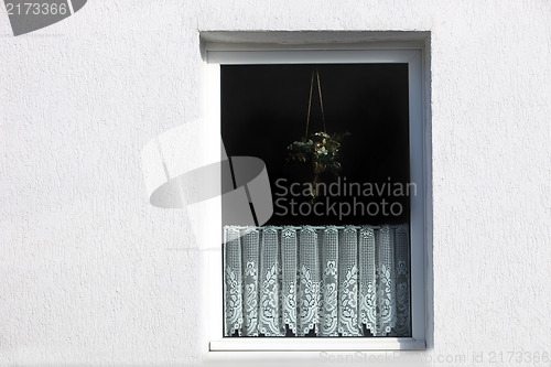 Image of Window with decorative net curtain