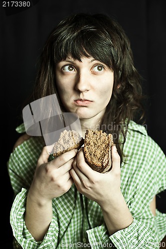 Image of beggar woman eating bread 