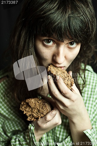 Image of beggar woman eating bread 