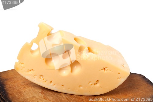 Image of Piece of cheese on old wooden kitchen table