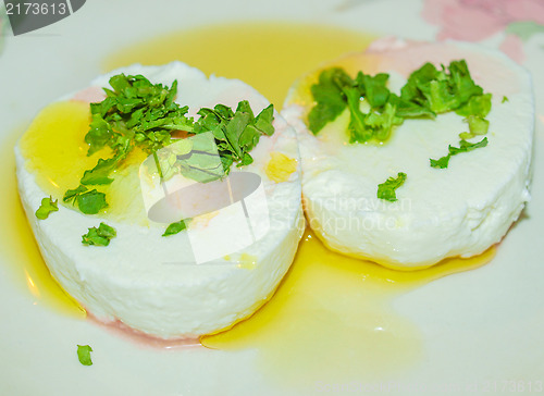 Image of Tomino cheese with rucola and olive oil