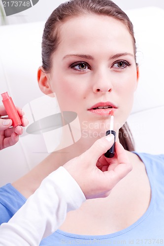 Image of woman applying lipstick on lips natural beauty