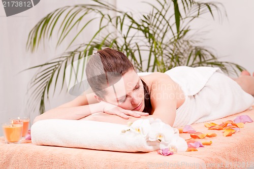 Image of young attractive smilig woman doing wellness spa