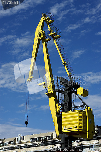 Image of house sky clouds and yellow crane 