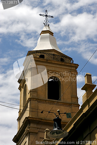 Image of the yellow brick tower facade street lamp 