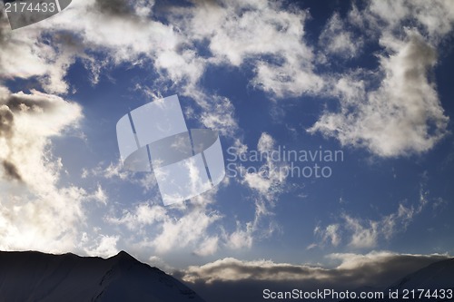 Image of Blue sky with clouds and mountains in evening