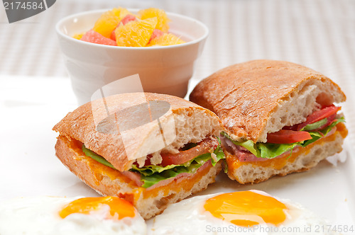 Image of ciabatta panini sandwich eggs tomato lettuce