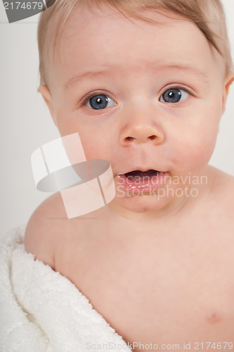 Image of Little boy in white blanket