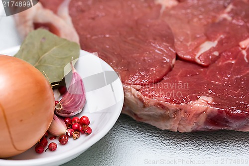 Image of Beef steak with bowl of spices