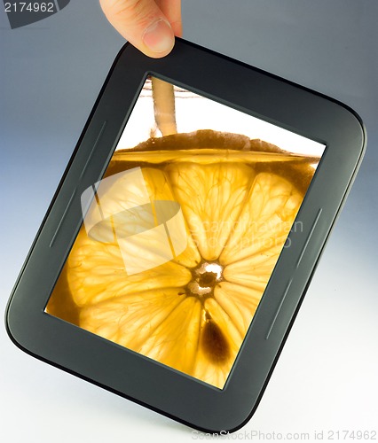 Image of tablet touch pad computer with lemon