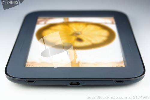 Image of tablet touch pad computer with lemon