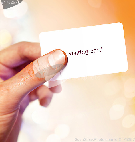 Image of White visit card in hand