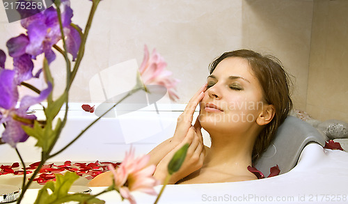 Image of woman in a bath with rose-petals