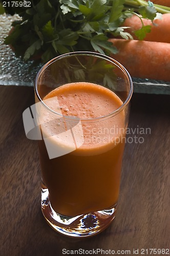 Image of carrot juice on a wooden background 