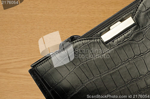 Image of A black business bag on a wooden background