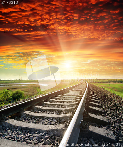 Image of railroad to red sunset