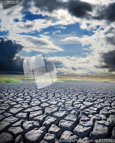 Image of view to dry lake and dramatic sky over it