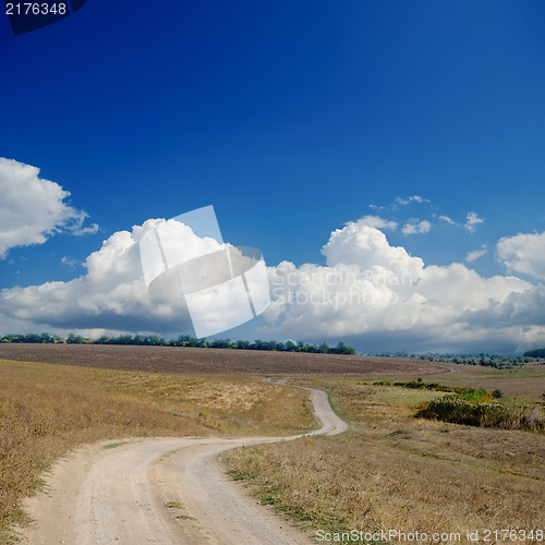 Image of rural road under dramatic cloudy sky