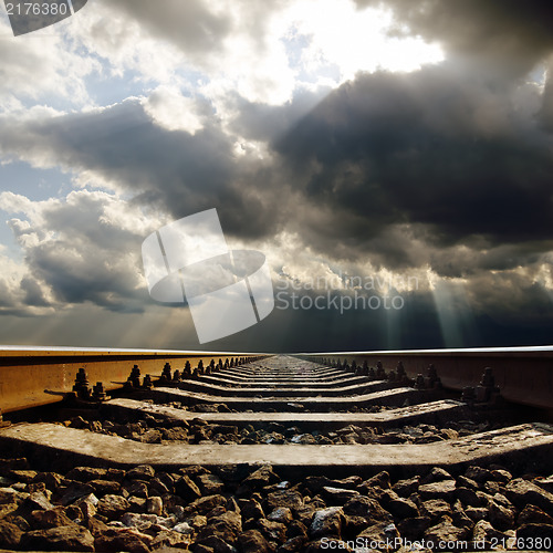 Image of railroad under dramatic sky
