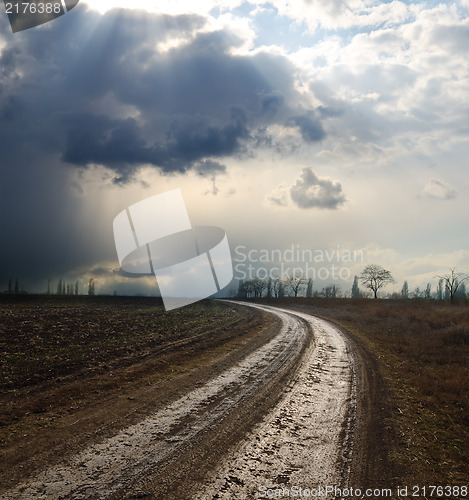 Image of dramatic sky over field with dirty road