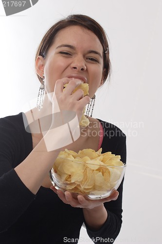 Image of Woman eating chips
