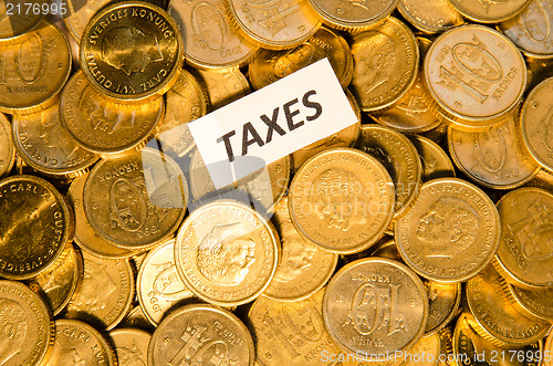 Image of Taxes sign on golden coins