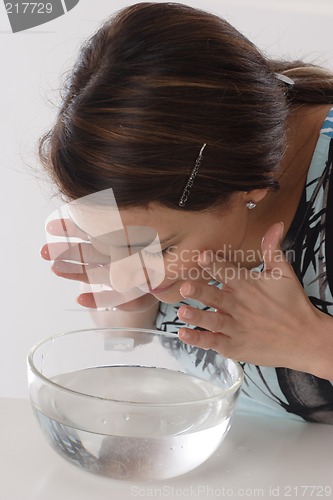 Image of Woman cleaning face