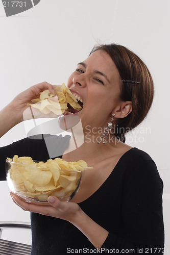 Image of Woman eating chips