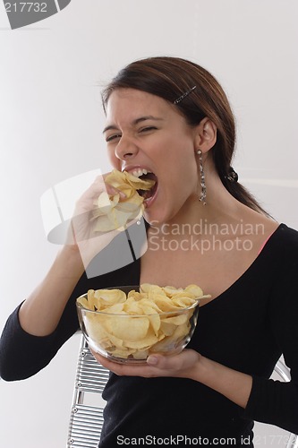 Image of Woman eating chips
