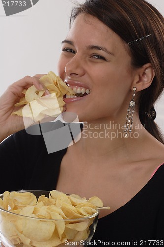 Image of Woman eating chips