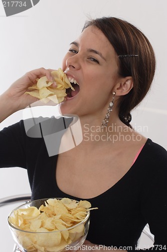 Image of Woman eating chips