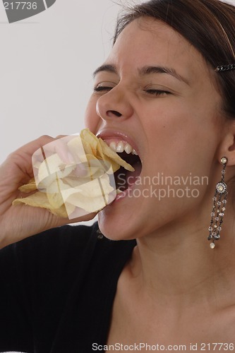 Image of Woman eating chips