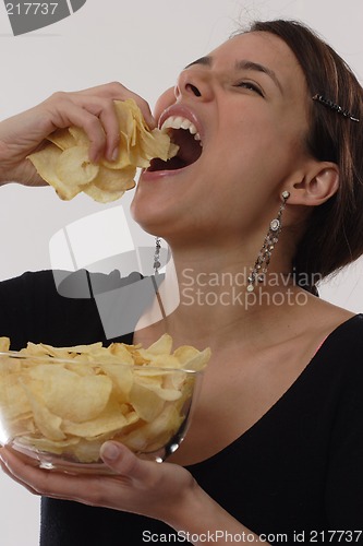 Image of Woman eating chips
