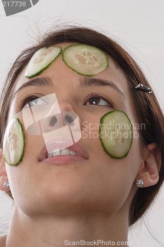 Image of Woman with cucumber slices