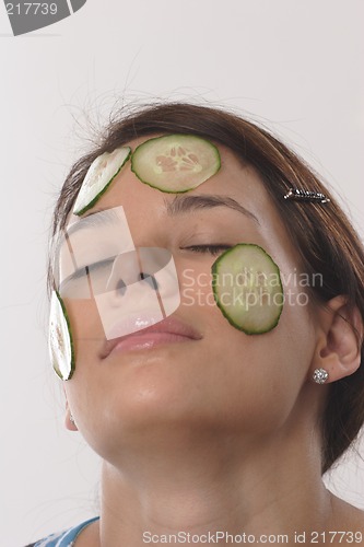 Image of Woman with cucumber slices
