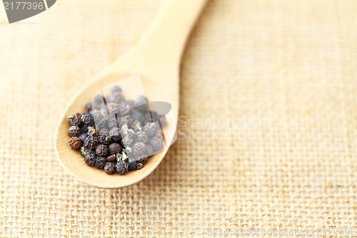 Image of pepper in wooden spoon