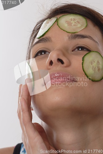 Image of Woman with cucumber slices