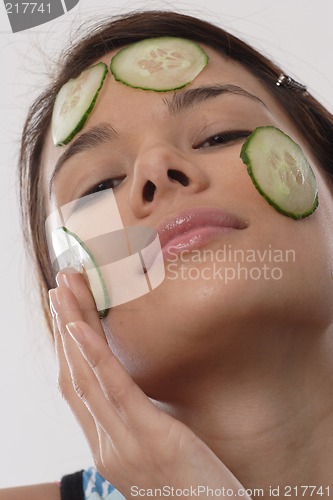 Image of Woman with cucumber slices