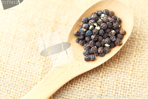 Image of pepper in wooden spoon