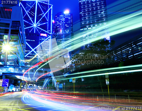 Image of moving car with blur light through city at night