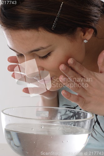 Image of Woman cleaning face