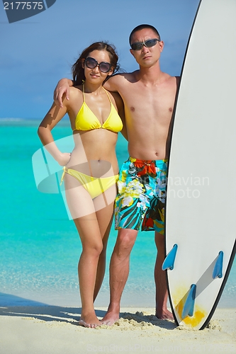 Image of happy young  couple enjoying summer on beach