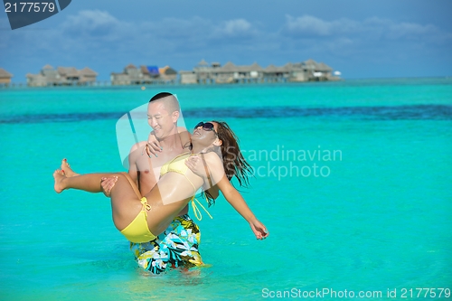 Image of happy young  couple enjoying summer on beach