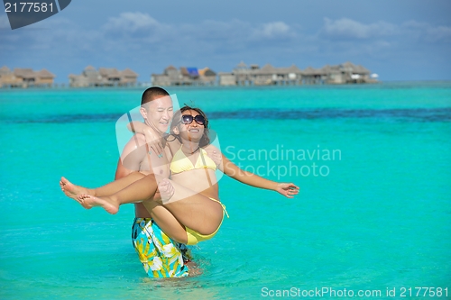 Image of happy young  couple enjoying summer on beach