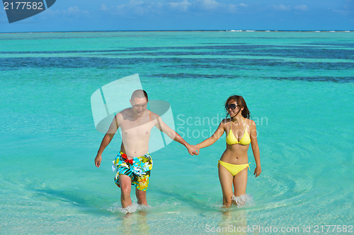 Image of happy young  couple enjoying summer on beach