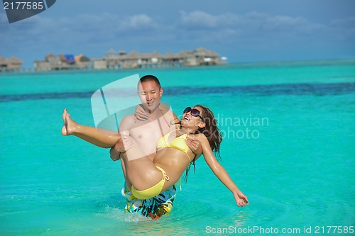 Image of happy young  couple enjoying summer on beach