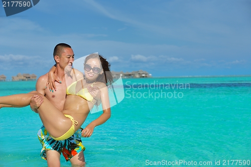 Image of happy young  couple enjoying summer on beach