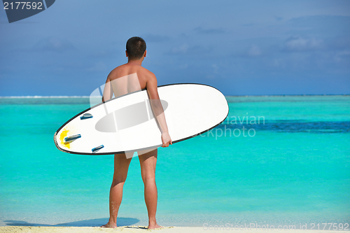 Image of Man with surf board on beach