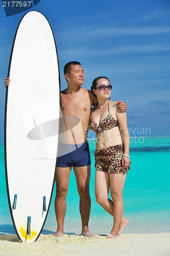 Image of happy young  couple enjoying summer on beach